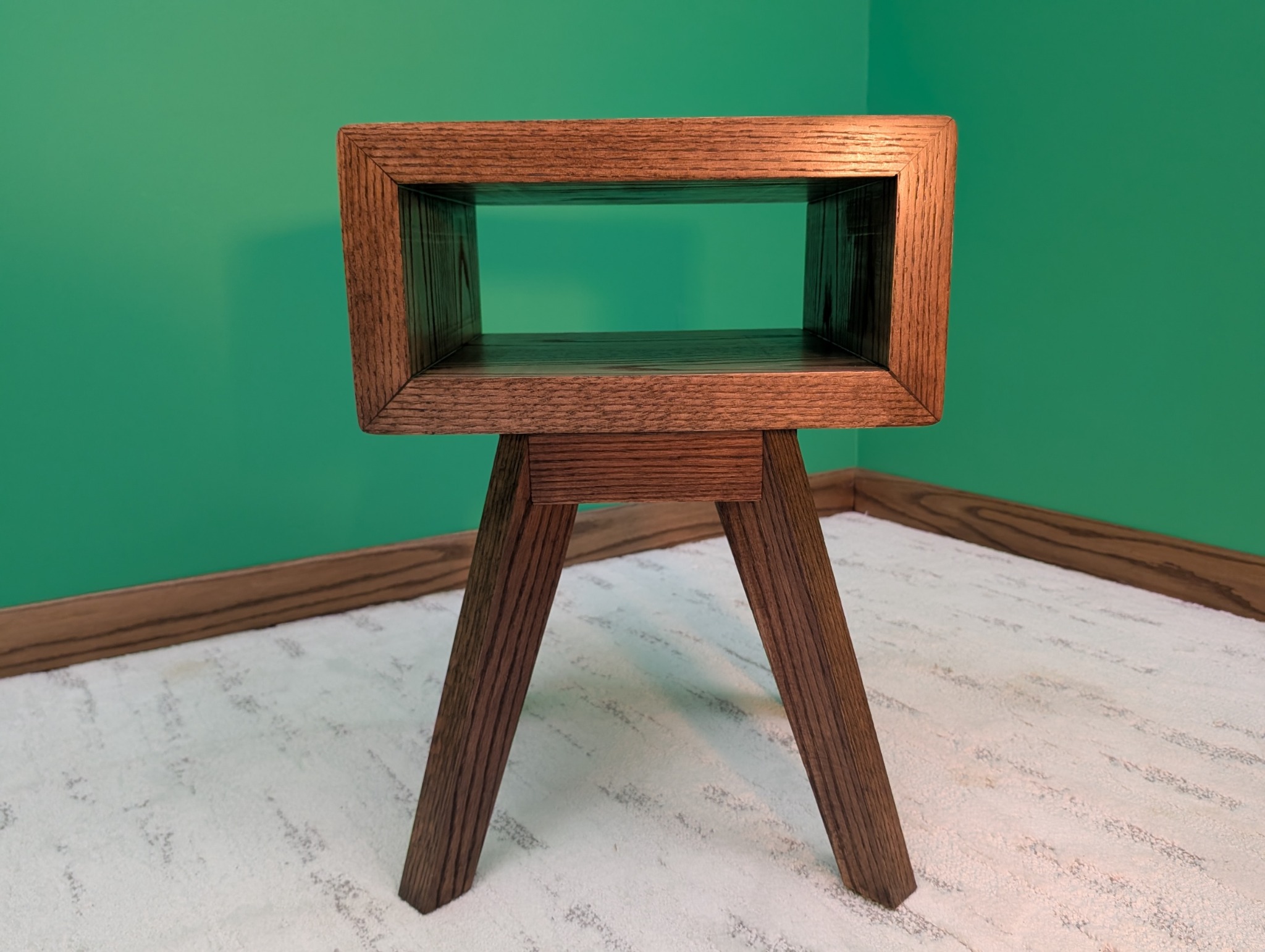 Straight-on view of the empty oak chairside table